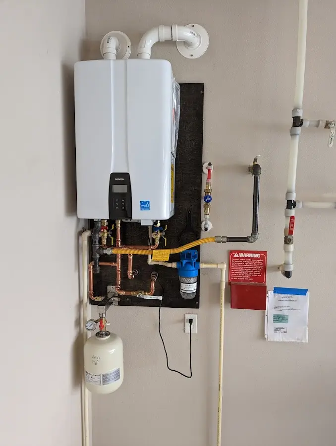 Professional plumber installing copper piping in a Old Jamestown home